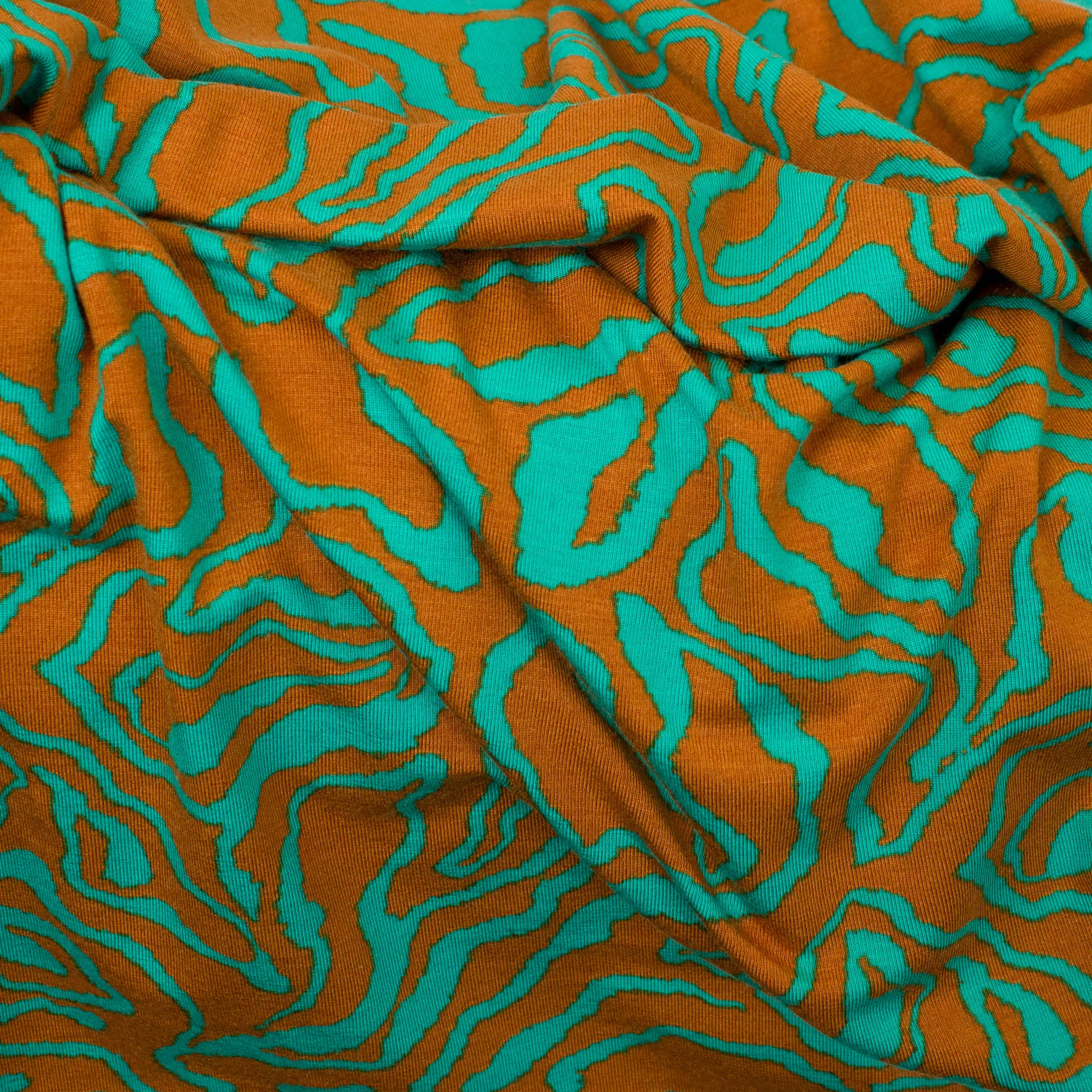 Tencel modal tricot met roestbruin / petrol abstracte lijnen